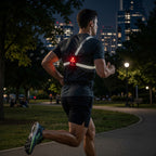 Rear view of runner wearing LUMEFIT chest light with reflective straps and red safety light